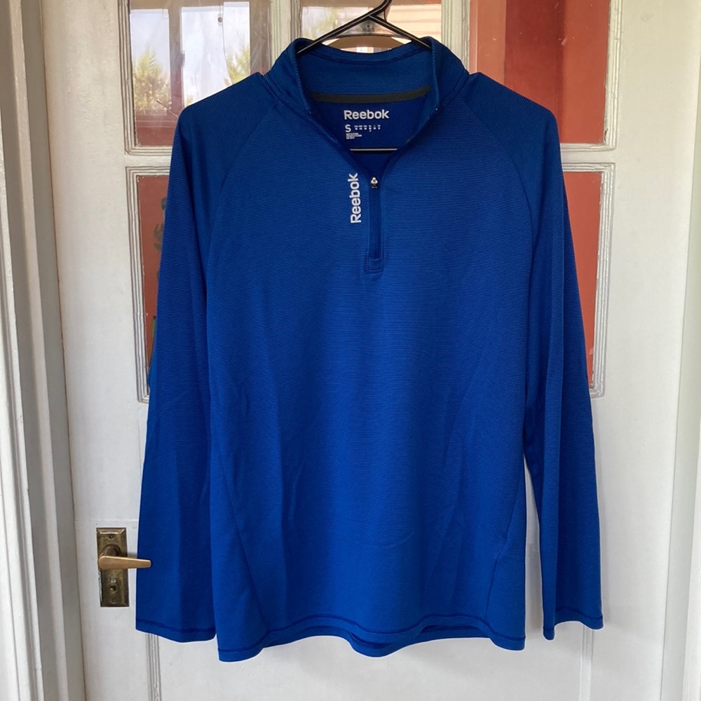Blue Reebok quarter-zip long-sleeve shirt.